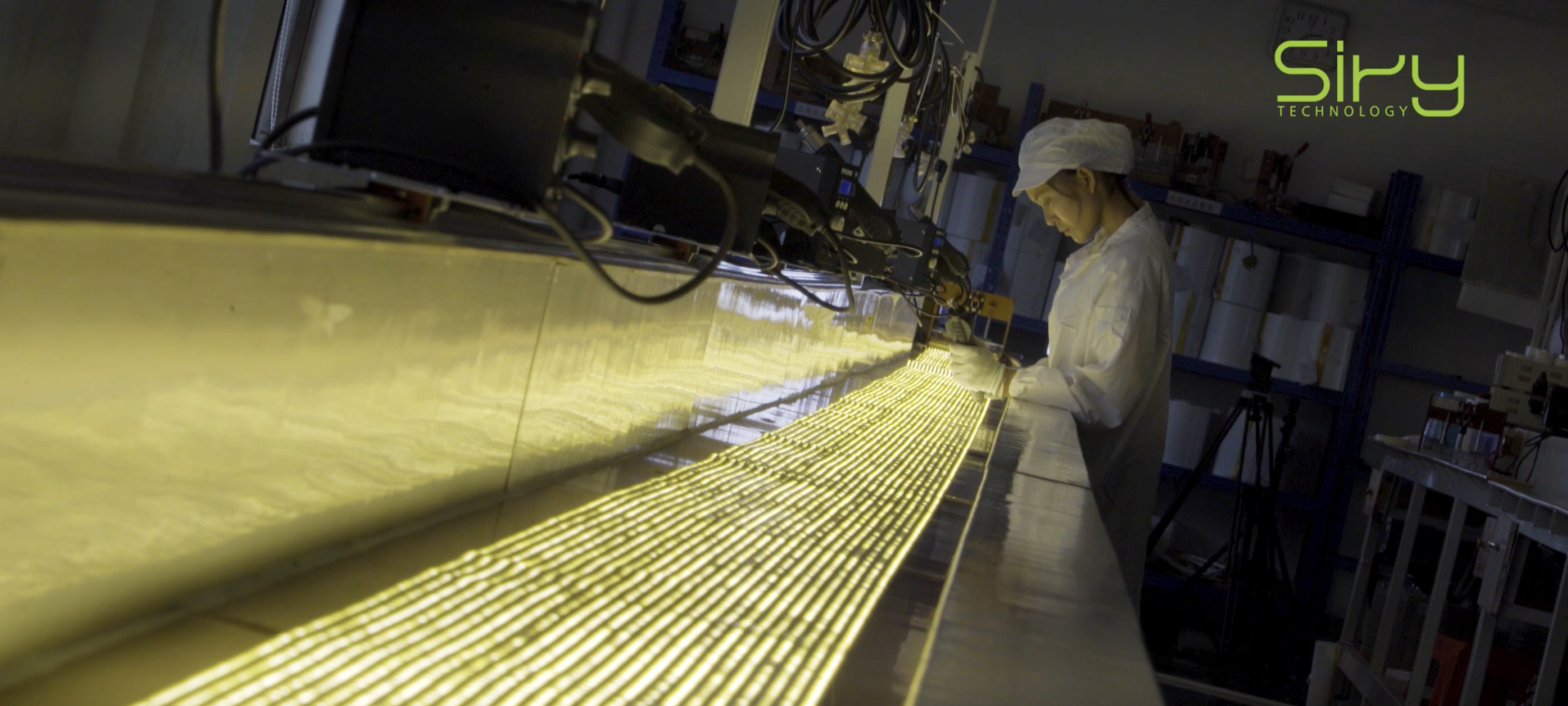 Lighting entrepreneur reviewing an LED strip production plan in a factory