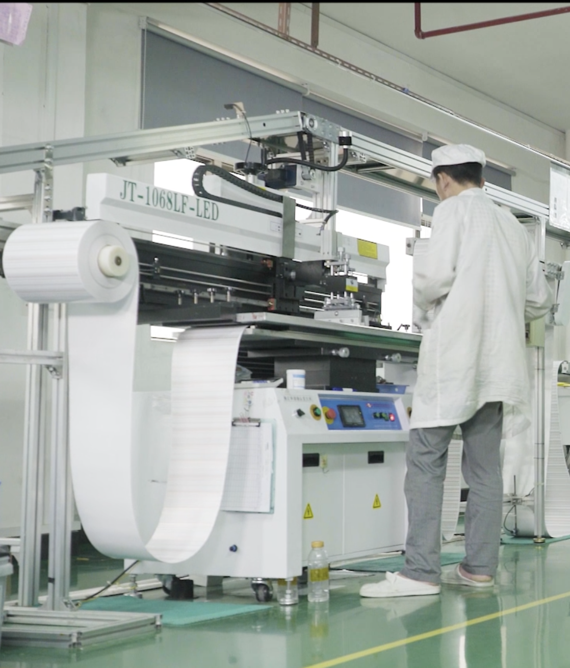Lighting entrepreneur reviewing an LED strip production plan in a factory